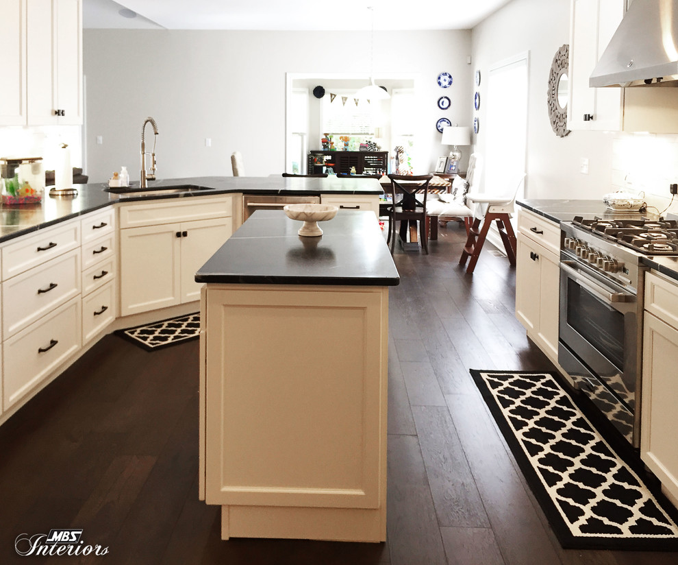 Inspiration for a mid-sized transitional u-shaped dark wood floor and brown floor eat-in kitchen remodel with an undermount sink, recessed-panel cabinets, white cabinets, soapstone countertops, white backsplash, subway tile backsplash, stainless steel appliances and an island