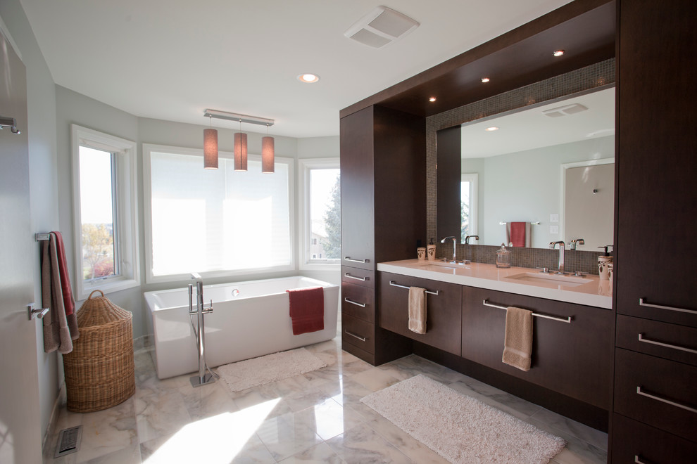 Design ideas for a contemporary bathroom in Calgary with a freestanding tub and flat-panel cabinets.