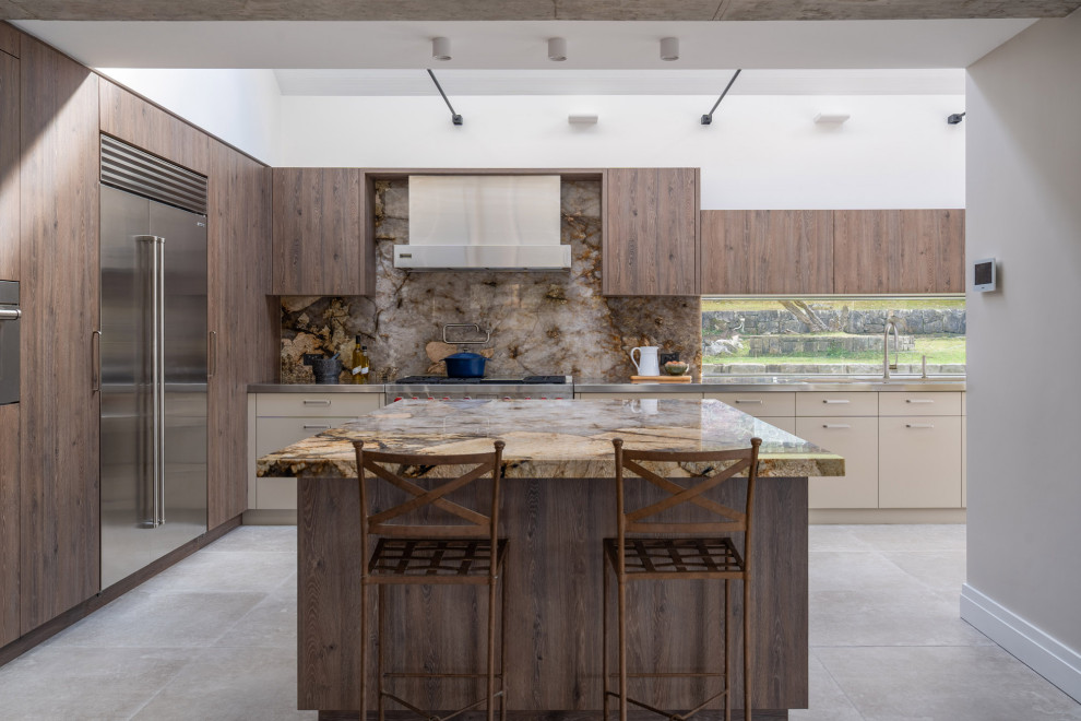 Design ideas for a large contemporary l-shaped open plan kitchen in Sydney with an integrated sink, flat-panel cabinets, medium wood cabinets, quartzite benchtops, multi-coloured splashback, stone slab splashback, stainless steel appliances, porcelain floors, with island, grey floor, multi-coloured benchtop and vaulted.