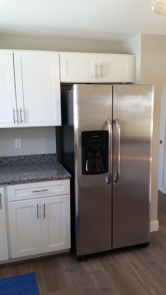 Eat-in kitchen - mid-sized transitional l-shaped eat-in kitchen idea in Providence with a single-bowl sink, shaker cabinets, white cabinets, granite countertops, stainless steel appliances and a peninsula