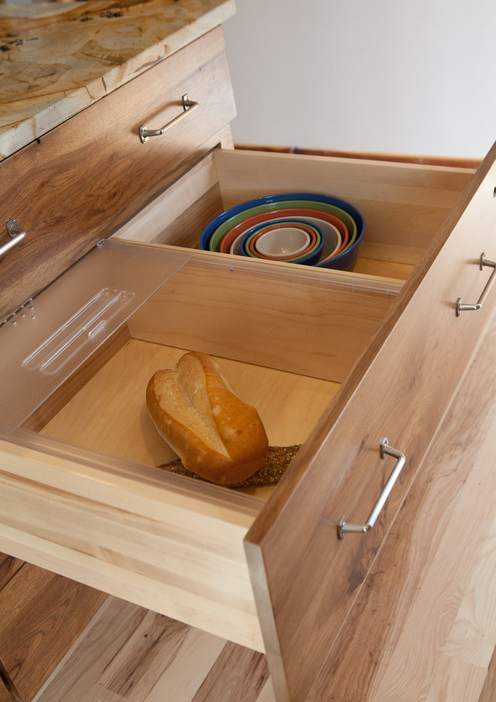 Mid-sized mountain style l-shaped light wood floor eat-in kitchen photo in Indianapolis with a single-bowl sink, flat-panel cabinets, medium tone wood cabinets, white backsplash, subway tile backsplash, paneled appliances, white walls, an island, quartzite countertops and multicolored countertops