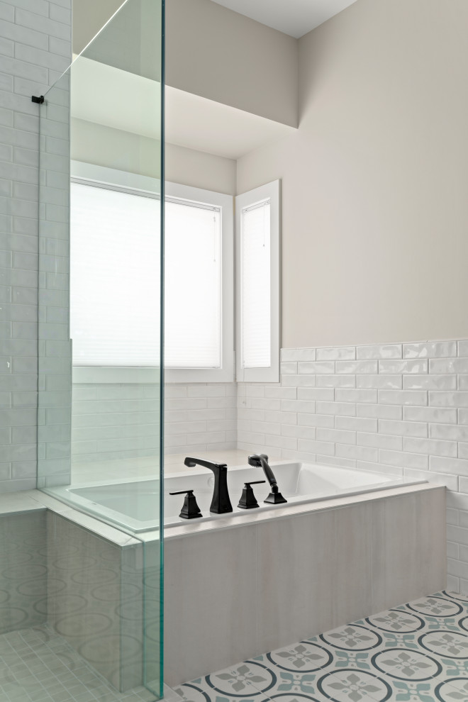 Example of a large transitional master white tile and ceramic tile ceramic tile, multicolored floor and double-sink drop-in bathtub design in Calgary with raised-panel cabinets, brown cabinets, beige walls, an undermount sink, quartzite countertops, a hinged shower door, white countertops and a built-in vanity