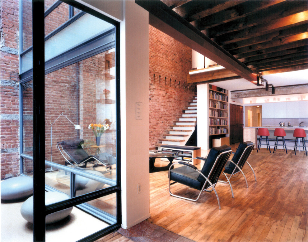 Mid-sized contemporary formal loft-style living room in New York with white walls and no tv.