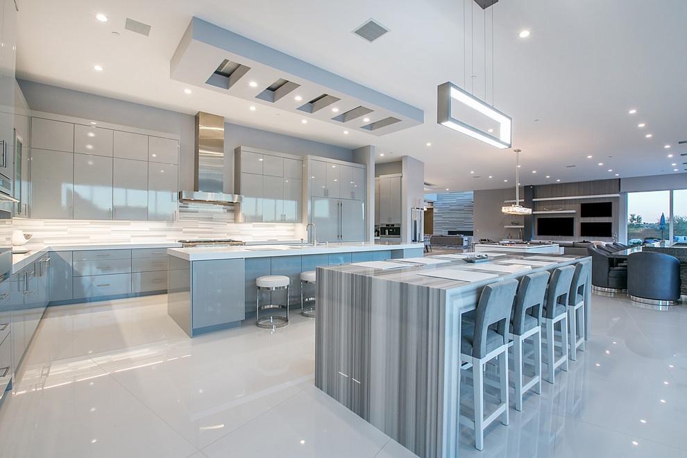 Inspiration for an expansive contemporary open plan kitchen in Las Vegas with flat-panel cabinets, grey cabinets, multi-coloured splashback, panelled appliances and multiple islands.