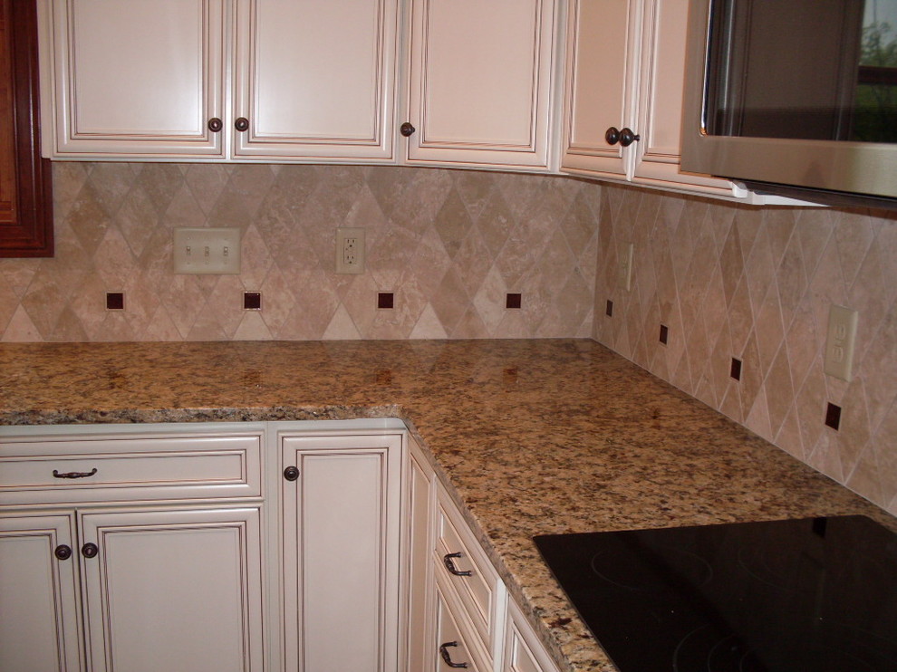 Inspiration for a mid-sized transitional u-shaped dark wood floor open concept kitchen remodel in Cincinnati with an undermount sink, recessed-panel cabinets, white cabinets, granite countertops, beige backsplash, ceramic backsplash, stainless steel appliances and an island