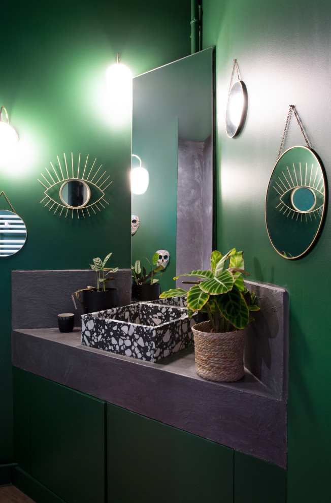 Пример оригинального дизайна: туалет в современном стиле с зелеными стенами, настольной раковиной и серой столешницей