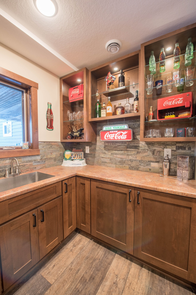 Design ideas for a small arts and crafts u-shaped home bar in Minneapolis with an undermount sink, shaker cabinets, medium wood cabinets, laminate benchtops, multi-coloured splashback, stone tile splashback, linoleum floors, brown floor and brown benchtop.
