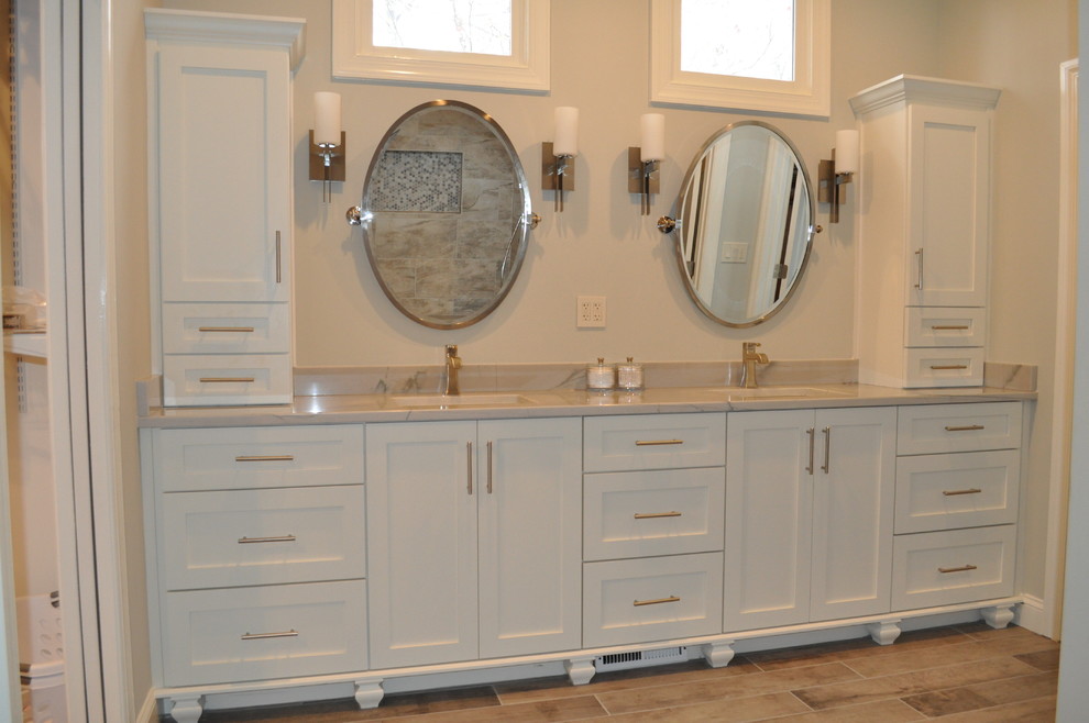 This is an example of a large traditional master bathroom in Atlanta with white cabinets, a double shower, gray tile, porcelain tile, grey walls, porcelain floors, an undermount sink, quartzite benchtops, shaker cabinets and a two-piece toilet.