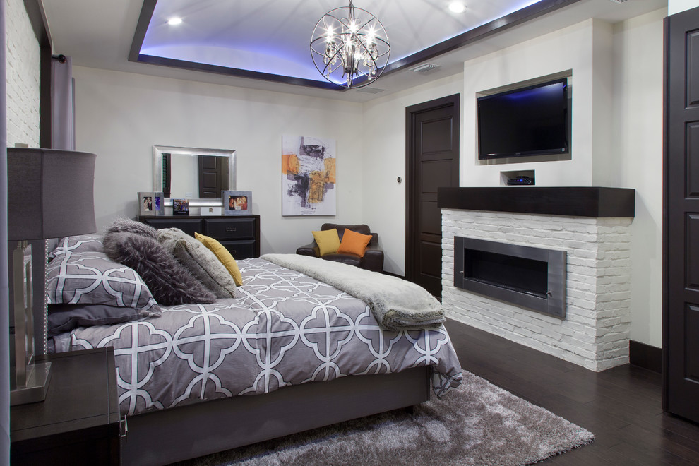 Photo of a mid-sized contemporary master bedroom in Orlando with white walls, dark hardwood floors, a brick fireplace surround and a ribbon fireplace.