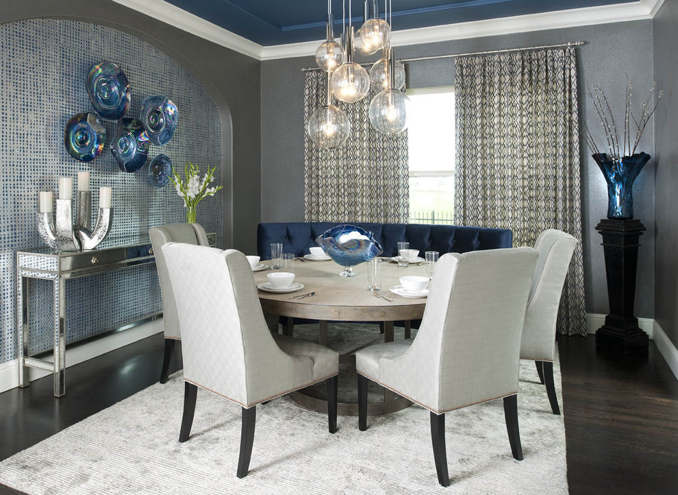 This is an example of a contemporary dining room in Dallas with grey walls and dark hardwood floors.