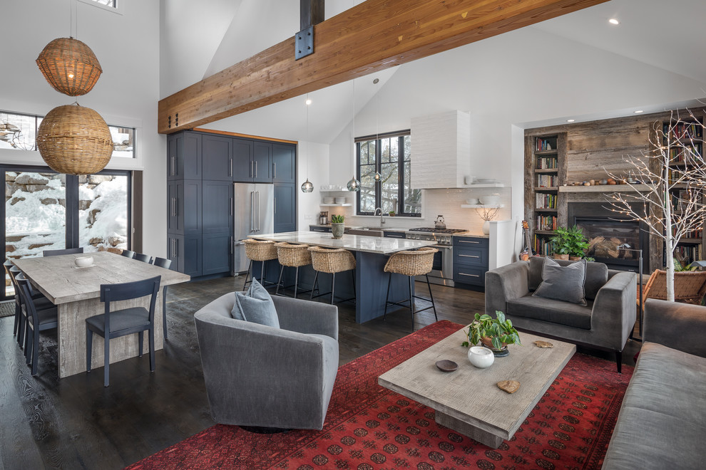 Living room library - rustic open concept dark wood floor living room library idea with white walls