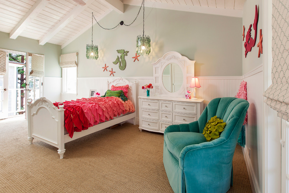 This is an example of a beach style kids' bedroom for girls in Orange County with grey walls and carpet.