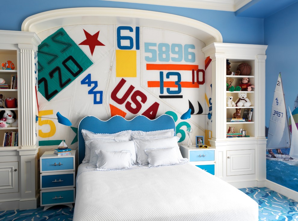 Design ideas for a beach style gender-neutral kids' bedroom for kids 4-10 years old in Boston with blue walls and carpet.