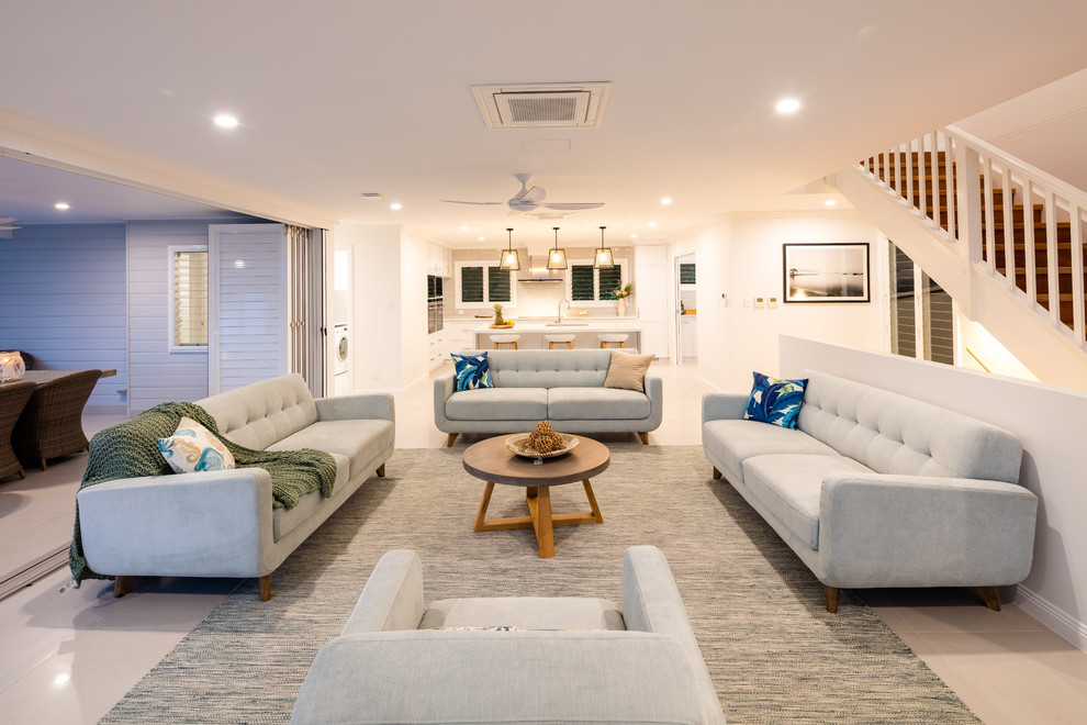 Contemporary formal open concept living room in Cairns with white walls, no fireplace, no tv and beige floor.