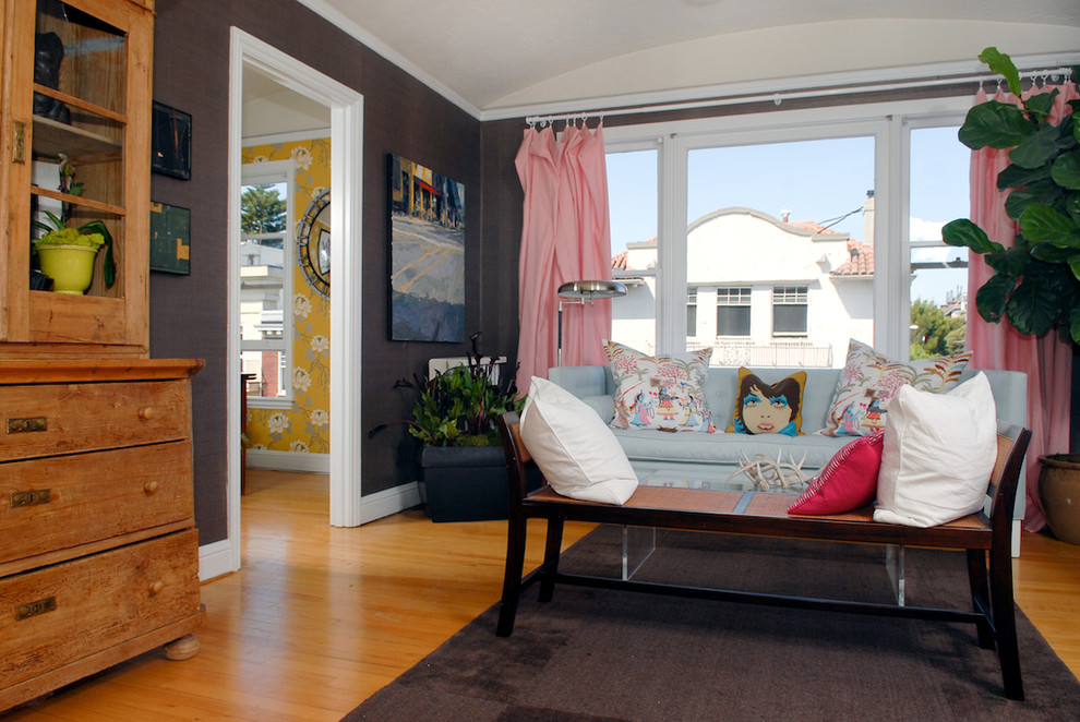This is an example of an eclectic living room in San Francisco with brown walls.