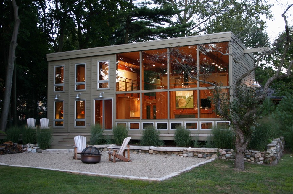 This is an example of a mid-sized modern two-storey green exterior in Chicago with wood siding.