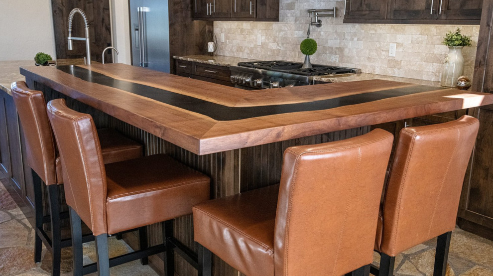 Inspiration for a large single-wall cement tile floor and gray floor eat-in kitchen remodel in Denver with an undermount sink, shaker cabinets, dark wood cabinets, granite countertops, beige backsplash, stone tile backsplash, stainless steel appliances, an island and beige countertops