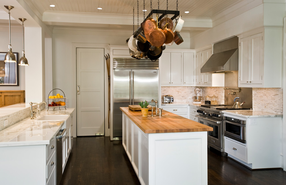 Inspiration for a traditional kitchen in Houston with a drop-in sink, shaker cabinets, white cabinets, wood benchtops, stainless steel appliances, dark hardwood floors and with island.