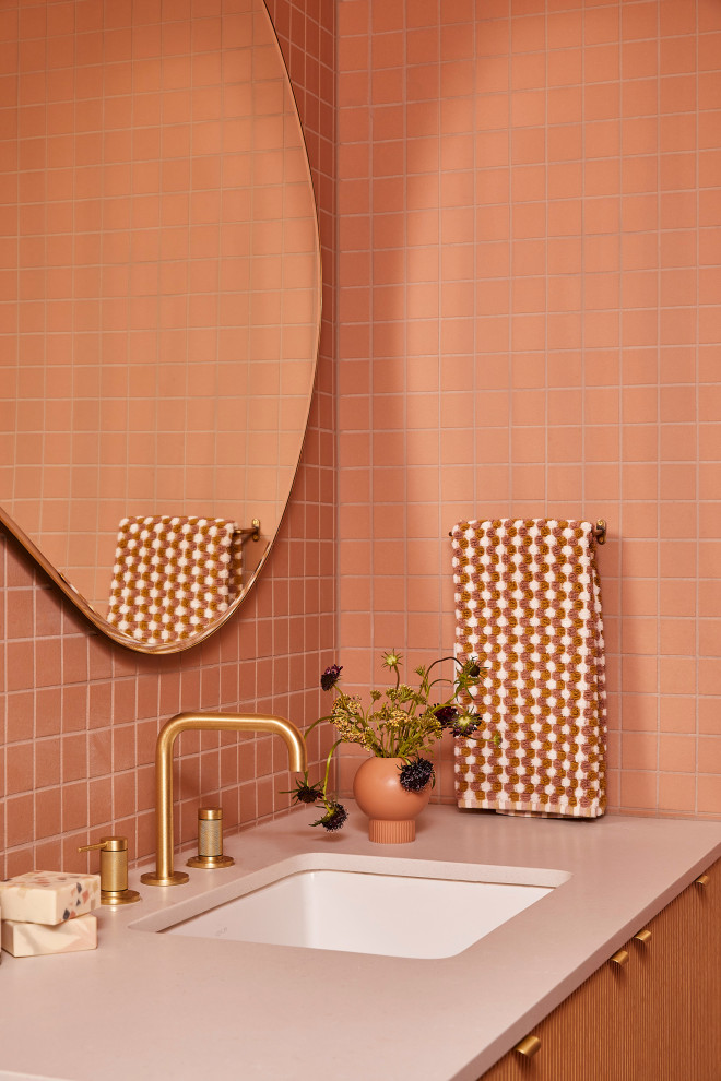 На фото: маленькая ванная комната в стиле ретро с светлыми деревянными фасадами, душем без бортиков, унитазом-моноблоком, розовой плиткой, керамической плиткой, розовыми стенами, полом из керамической плитки, врезной раковиной, столешницей из искусственного кварца, розовым полом, душем с распашными дверями, серой столешницей, нишей, тумбой под одну раковину и подвесной тумбой для на участке и в саду