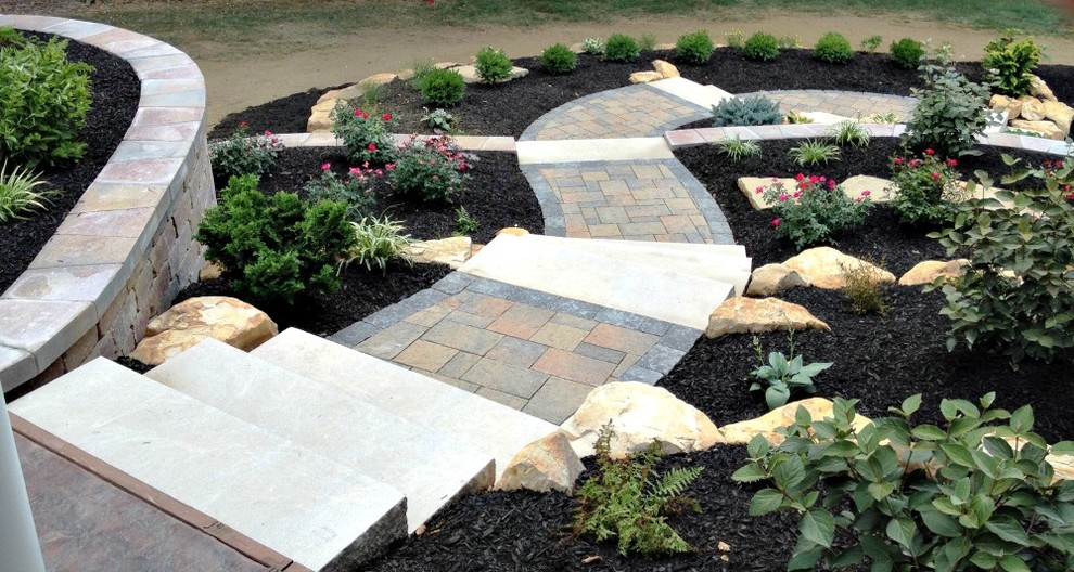 Inspiration for a mid-sized traditional backyard partial sun garden for summer in Indianapolis with a garden path and brick pavers.