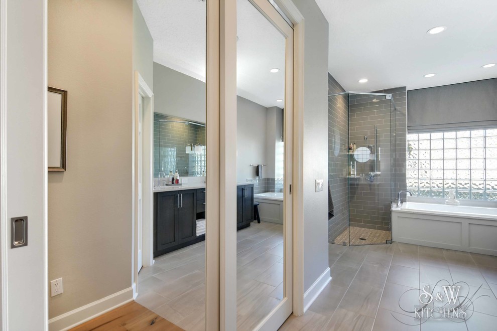 Inspiration for a mid-sized contemporary master bathroom in Tampa with shaker cabinets, grey cabinets, a drop-in tub, a curbless shower, a two-piece toilet, gray tile, cement tile, grey walls, porcelain floors, an undermount sink and engineered quartz benchtops.
