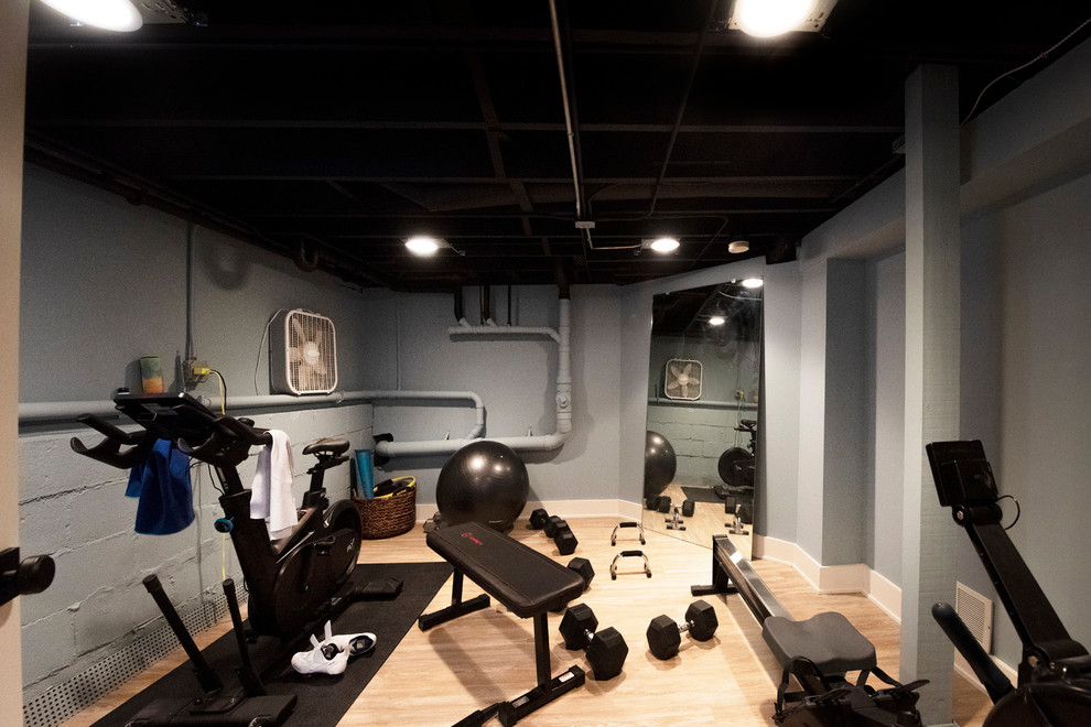 Photo of a small arts and crafts multipurpose gym in Chicago with grey walls, vinyl floors and brown floor.
