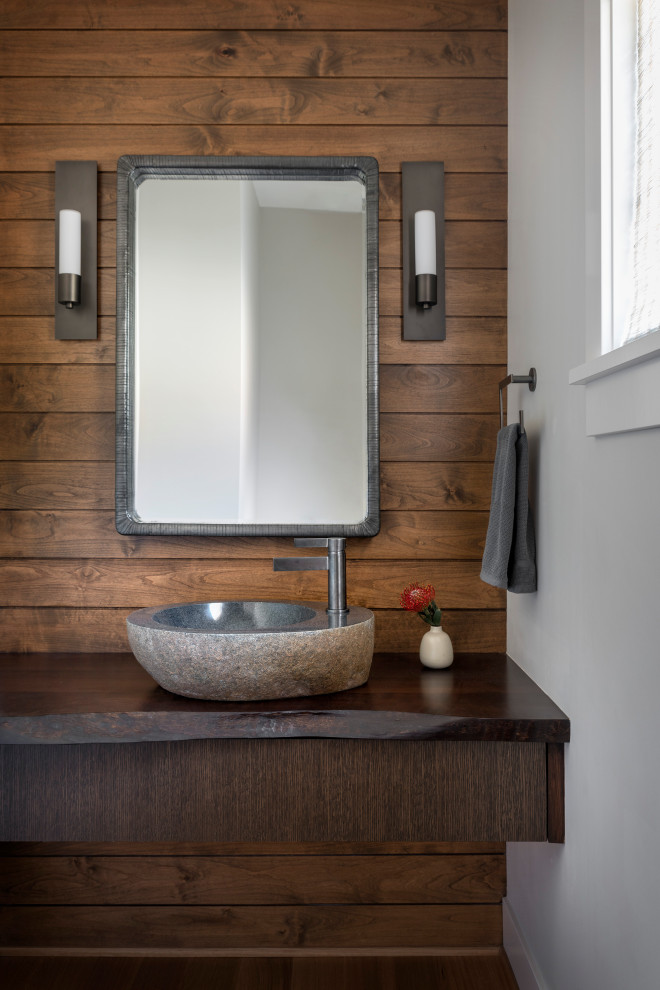 Design ideas for a mid-sized contemporary powder room in Seattle with flat-panel cabinets, dark wood cabinets, brown walls, a vessel sink, wood benchtops, brown benchtops, a floating vanity and planked wall panelling.
