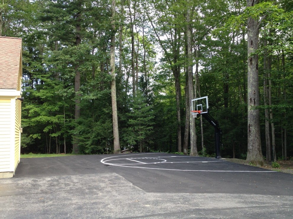 This is an example of a large traditional side yard partial sun outdoor sport court in Portland.