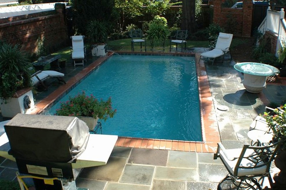 Pool fountain - mid-sized backyard stone and rectangular natural pool fountain idea