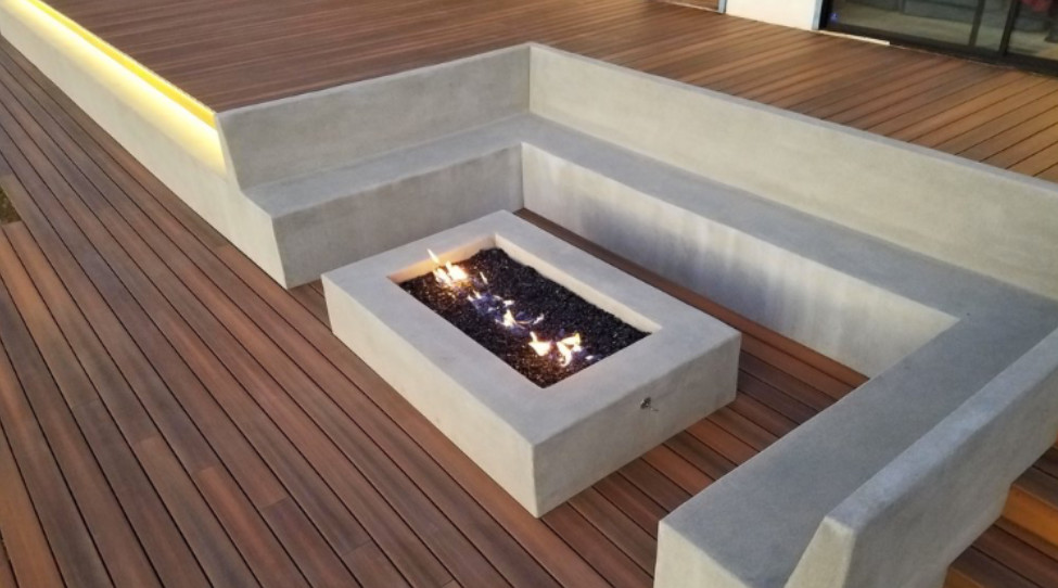 Mid-sized minimalist backyard deck photo in Orange County with a fire pit and no cover