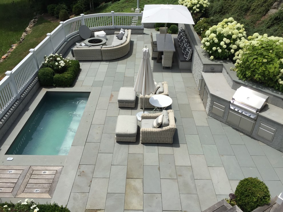 Photo of a small traditional backyard patio in New York with tile and no cover.