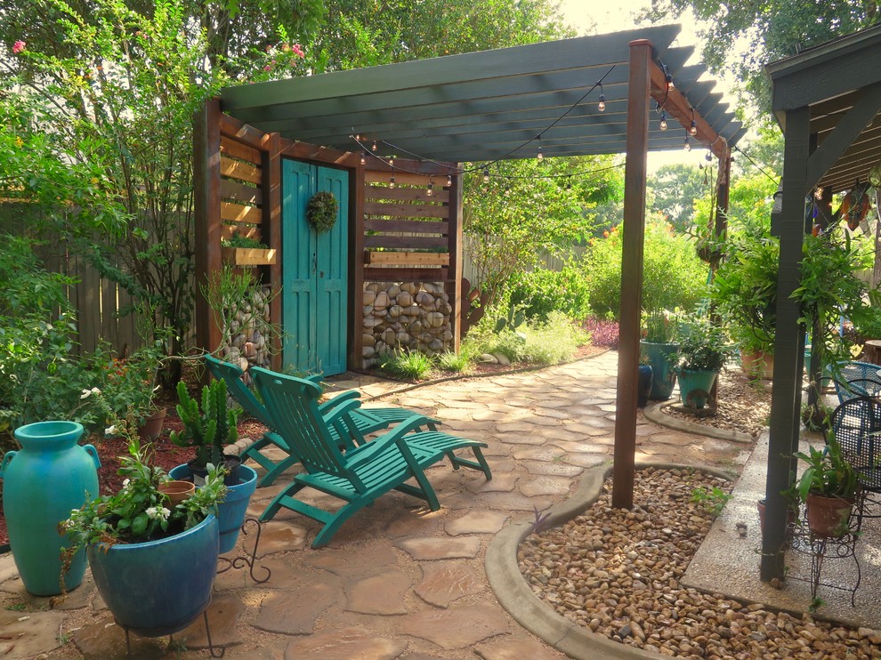 Inspiration for a mid-sized eclectic backyard patio in Austin with a container garden, concrete pavers and a pergola.