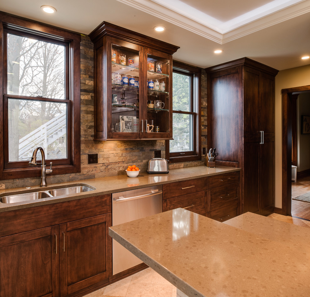 Inspiration for a mid-sized transitional l-shaped travertine floor eat-in kitchen remodel with an undermount sink, recessed-panel cabinets, dark wood cabinets, quartz countertops, multicolored backsplash, stone slab backsplash, stainless steel appliances and an island