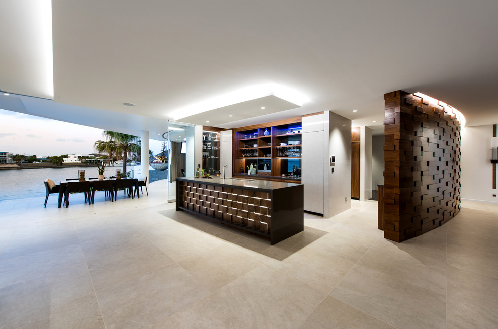 Inspiration for an expansive tropical galley open plan kitchen in Gold Coast - Tweed with an undermount sink, medium wood cabinets, granite benchtops, multi-coloured splashback, mirror splashback and with island.