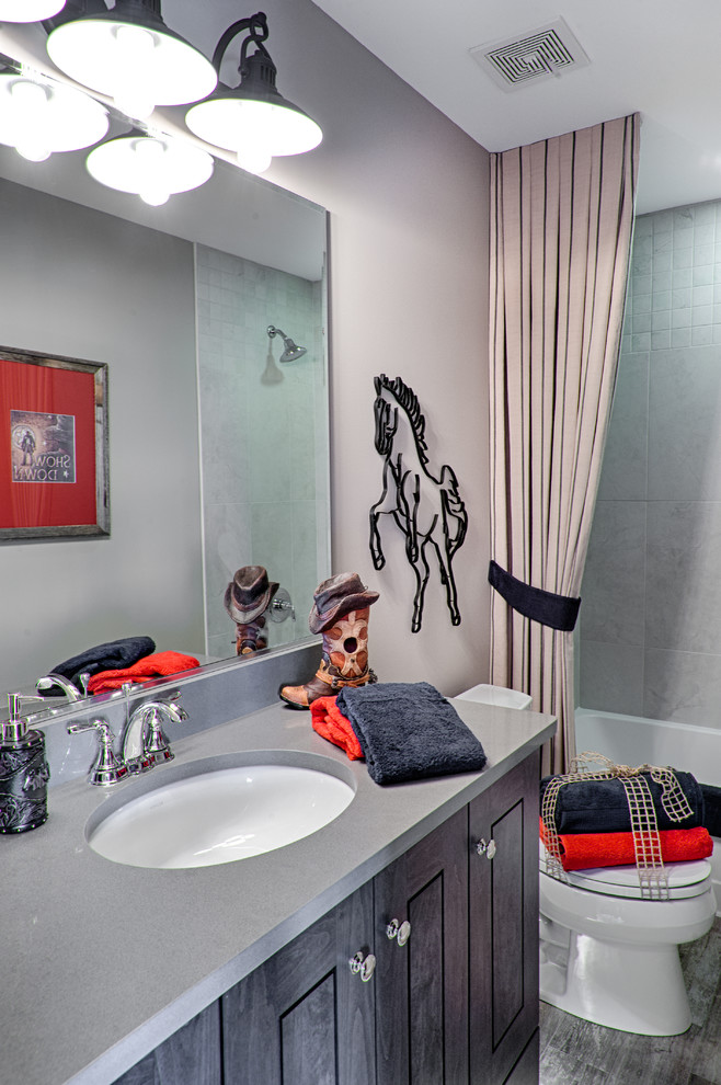 Alcove bathtub - rustic kids' gray tile and ceramic tile ceramic tile alcove bathtub idea in Chicago with flat-panel cabinets, medium tone wood cabinets, a two-piece toilet, gray walls, an undermount sink and quartz countertops