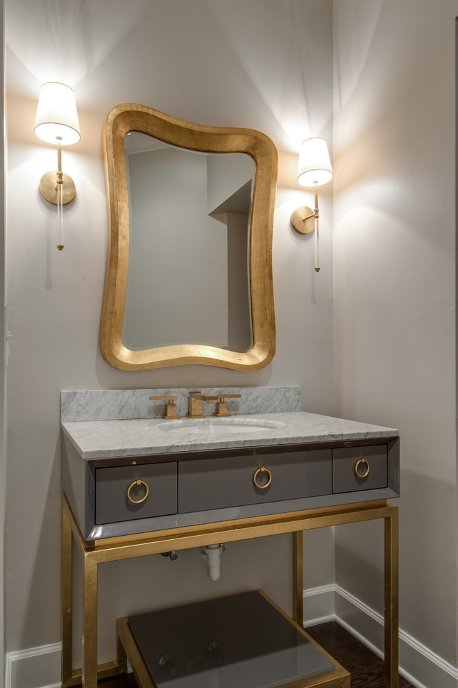 Photo of a mid-sized transitional powder room in Nashville with furniture-like cabinets, grey cabinets, white walls, dark hardwood floors, an undermount sink, marble benchtops, brown floor and grey benchtops.