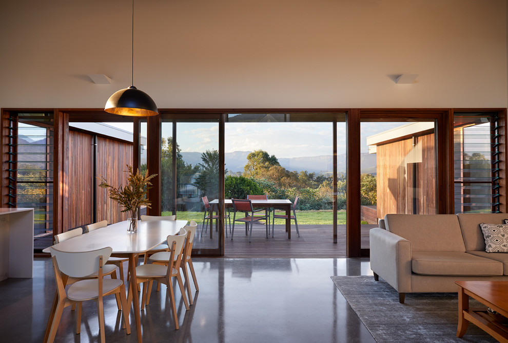 Inspiration for a contemporary open plan dining in Wollongong with white walls, concrete floors and grey floor.