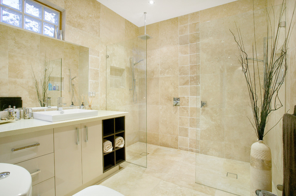 Photo of a large contemporary master bathroom in Melbourne with an open shower, a one-piece toilet, beige tile, stone tile and beige walls.