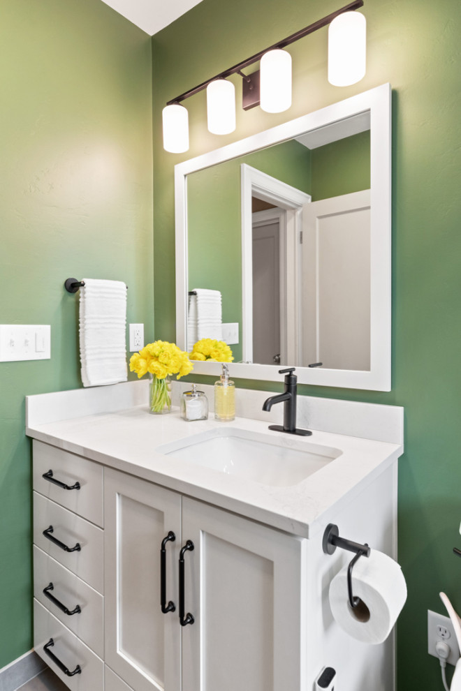 Example of a small white tile and ceramic tile slate floor, gray floor and single-sink alcove bathtub design with white cabinets, a bidet, green walls, an undermount sink, quartz countertops, white countertops and a built-in vanity