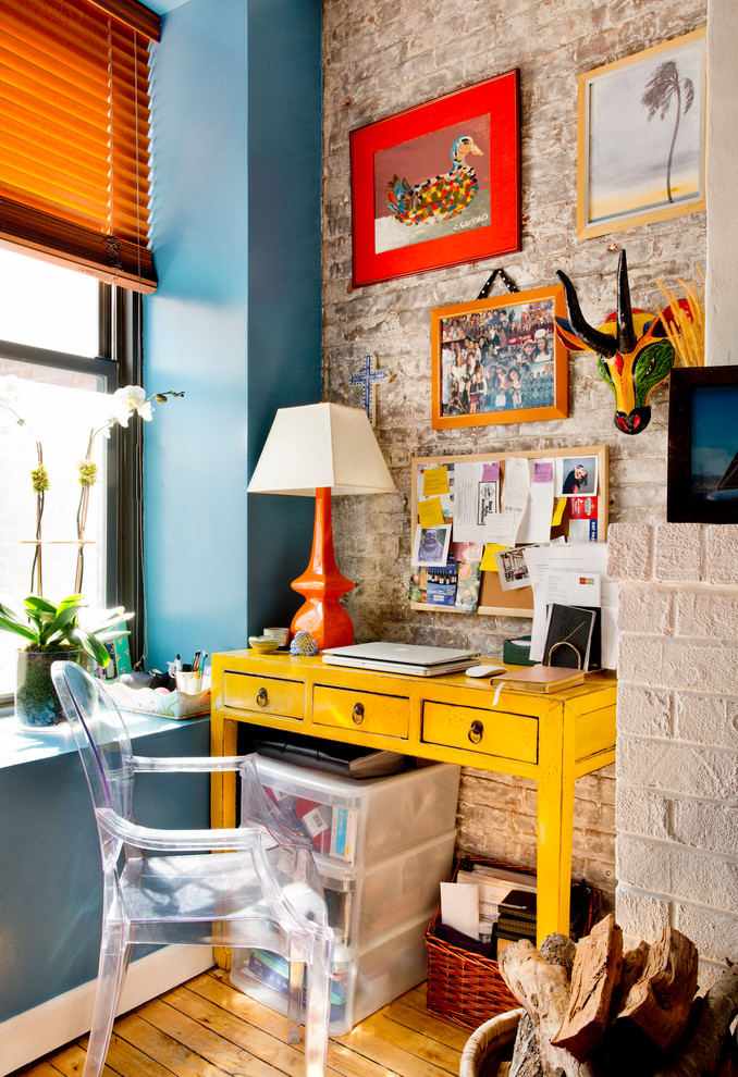 Inspiration for an eclectic study room in New York with medium hardwood floors and a freestanding desk.