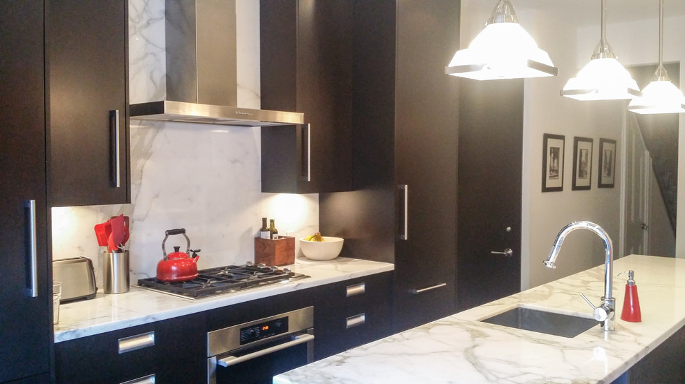 This is an example of a small contemporary galley eat-in kitchen in Toronto with an undermount sink, flat-panel cabinets, dark wood cabinets, marble benchtops, white splashback, stone slab splashback, stainless steel appliances, dark hardwood floors and with island.