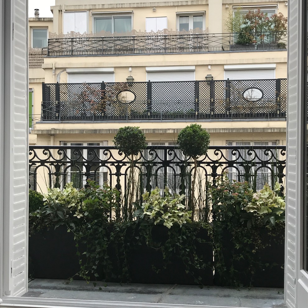 This is an example of a small transitional balcony for for apartments in Paris with no cover and metal railing.