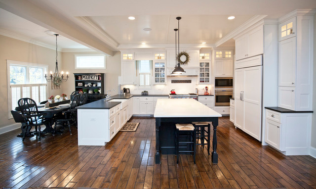 Inspiration for a large country u-shaped eat-in kitchen in Chicago with a farmhouse sink, recessed-panel cabinets, white cabinets, granite benchtops, white splashback, panelled appliances, medium hardwood floors, with island and ceramic splashback.