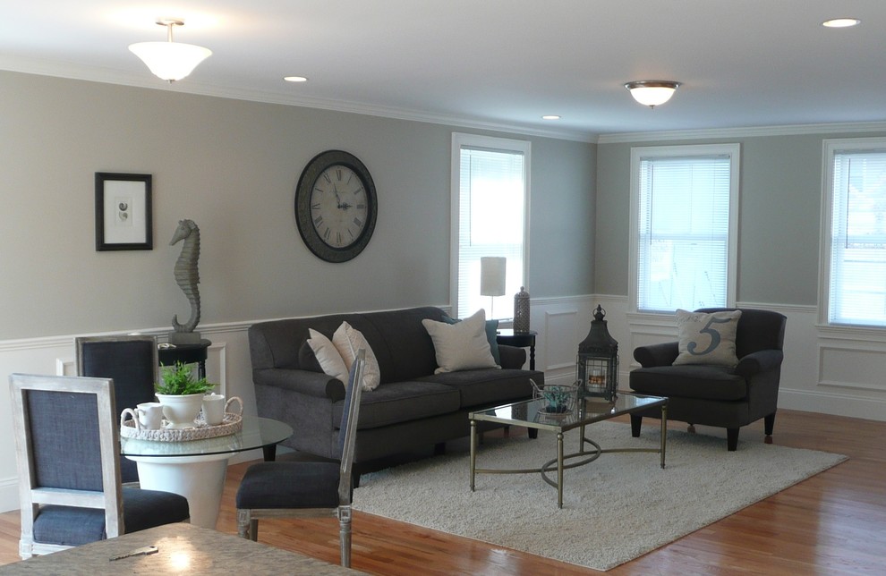 Inspiration for a mid-sized transitional open concept family room in Boston with grey walls and medium hardwood floors.