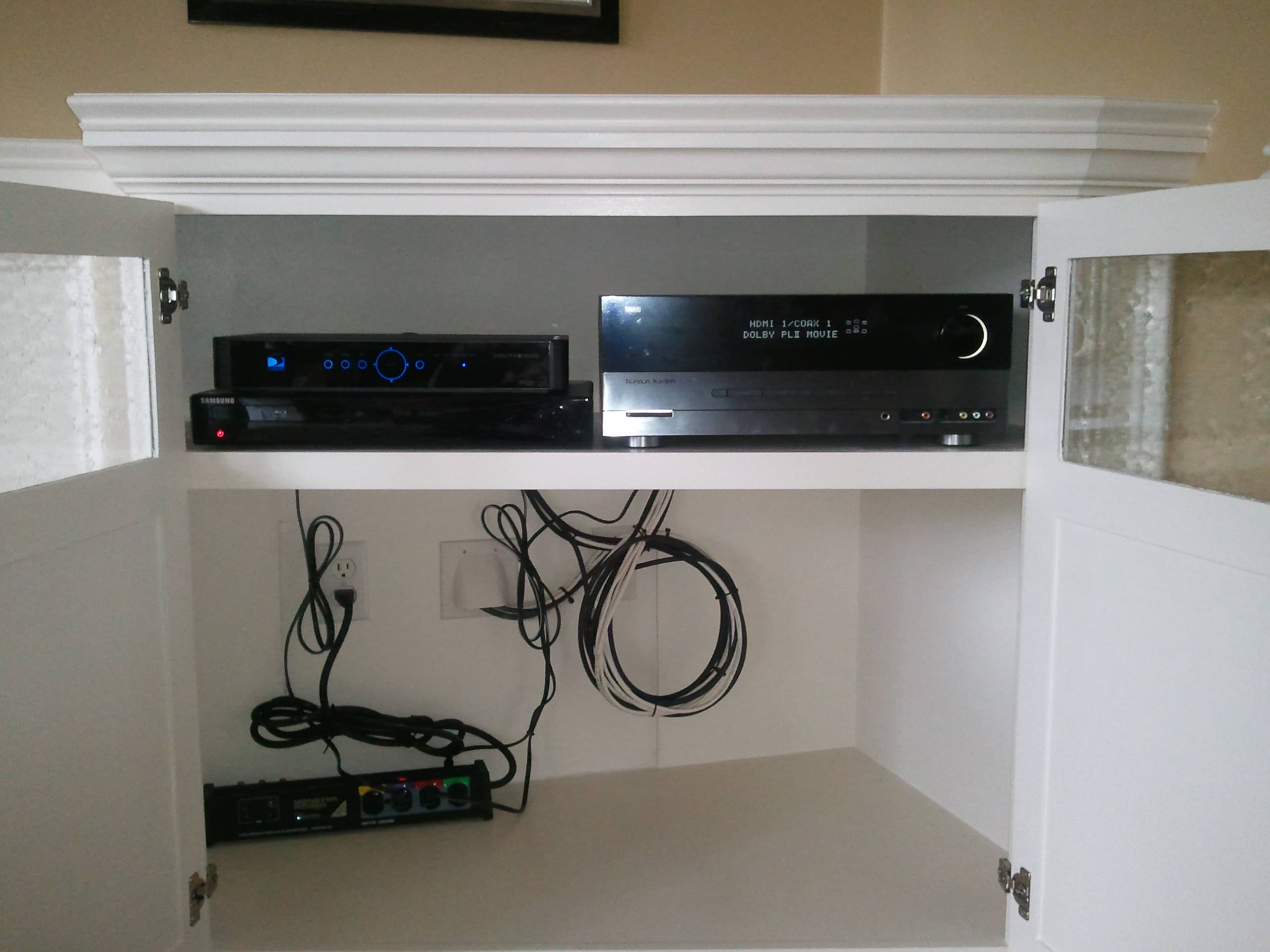 Built In Shelving and Cabinets To Hide Electronics and Surround Fireplace