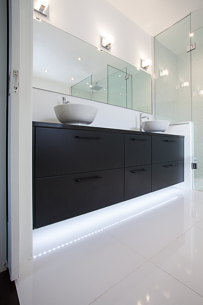 Photo of a mid-sized contemporary master bathroom in Ottawa with a vessel sink, flat-panel cabinets, dark wood cabinets and white walls.