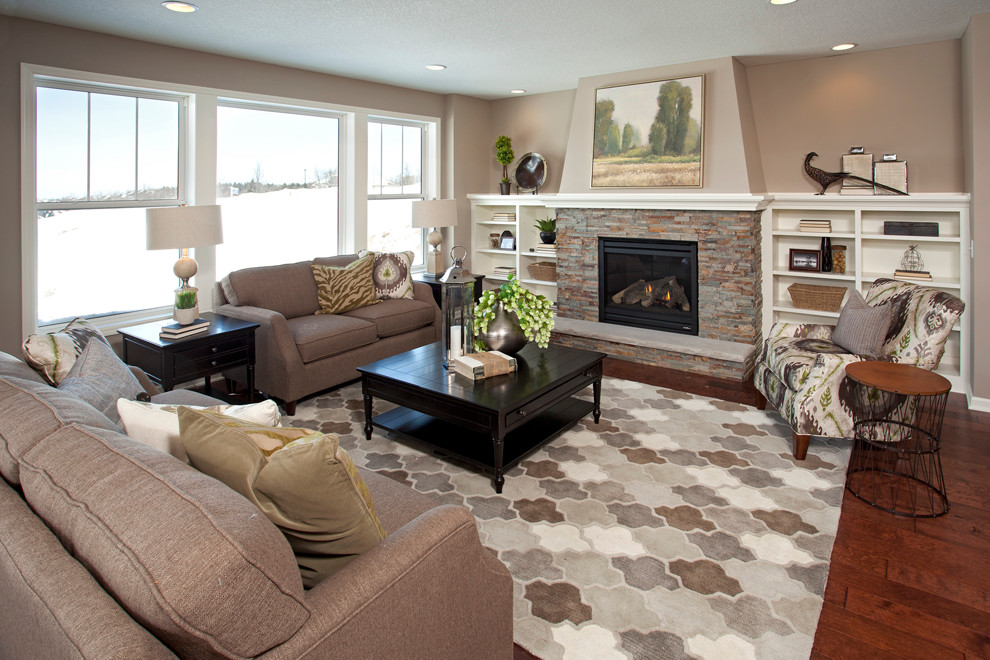 Traditional living room in Minneapolis with beige walls, a standard fireplace and a stone fireplace surround.