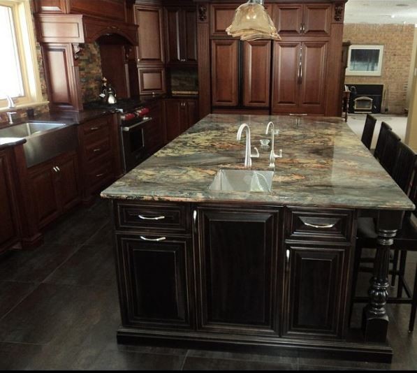 Inspiration for a large traditional l-shaped separate kitchen in Toronto with a farmhouse sink, raised-panel cabinets, dark wood cabinets, granite benchtops, multi-coloured splashback, matchstick tile splashback, panelled appliances, slate floors, with island, black floor and green benchtop.