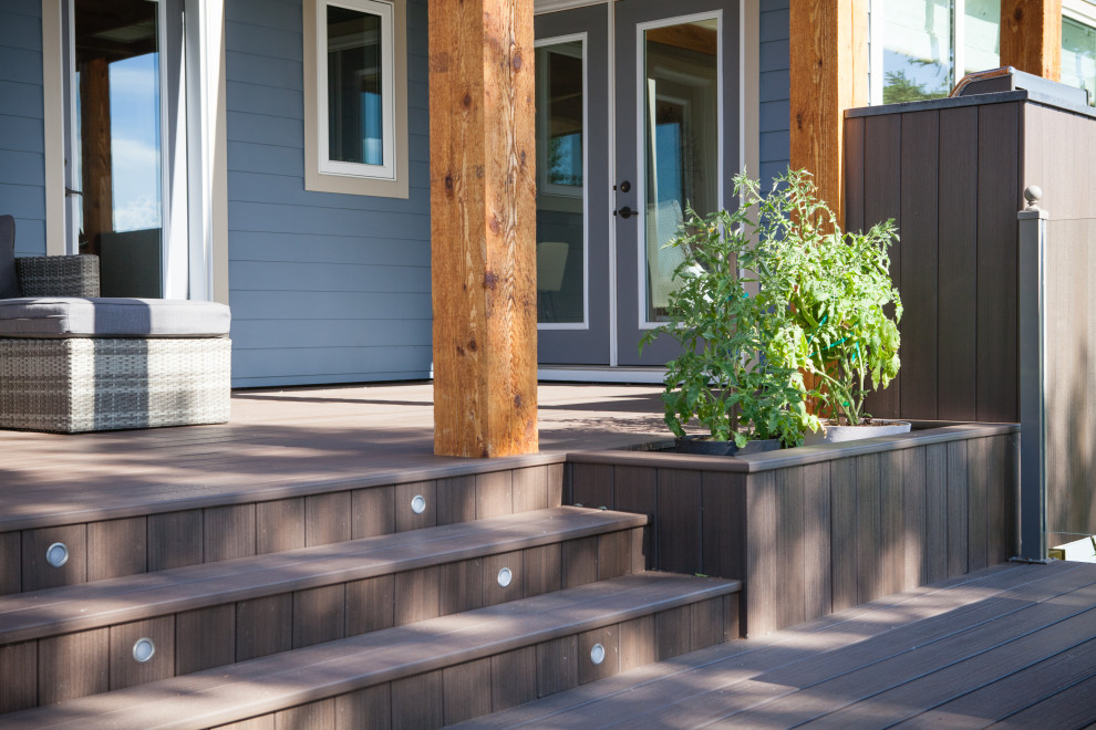 Inspiration for a mid-sized contemporary backyard deck remodel in Calgary with a pergola