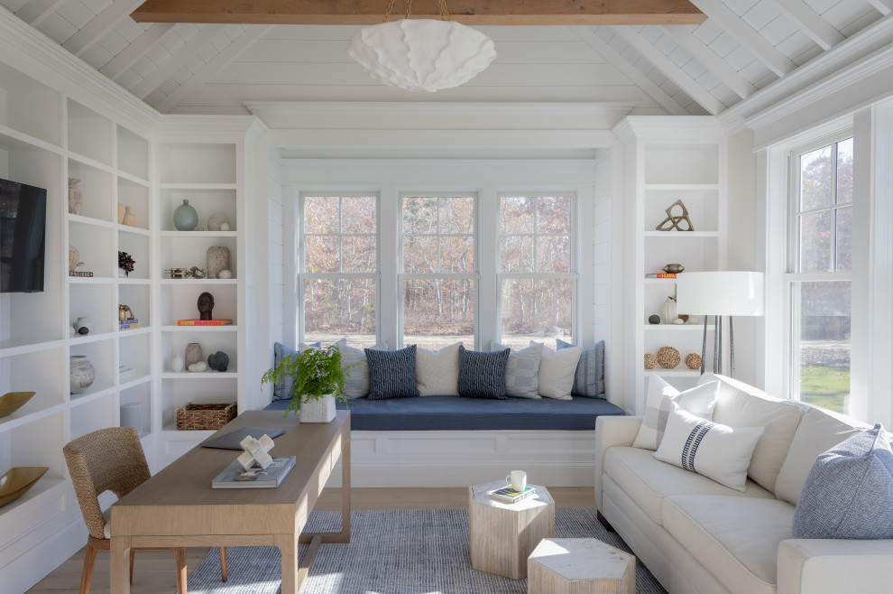 This is an example of a nautical home office in Boston with white walls, light hardwood flooring, a freestanding desk, beige floors, exposed beams, a timber clad ceiling and a vaulted ceiling.